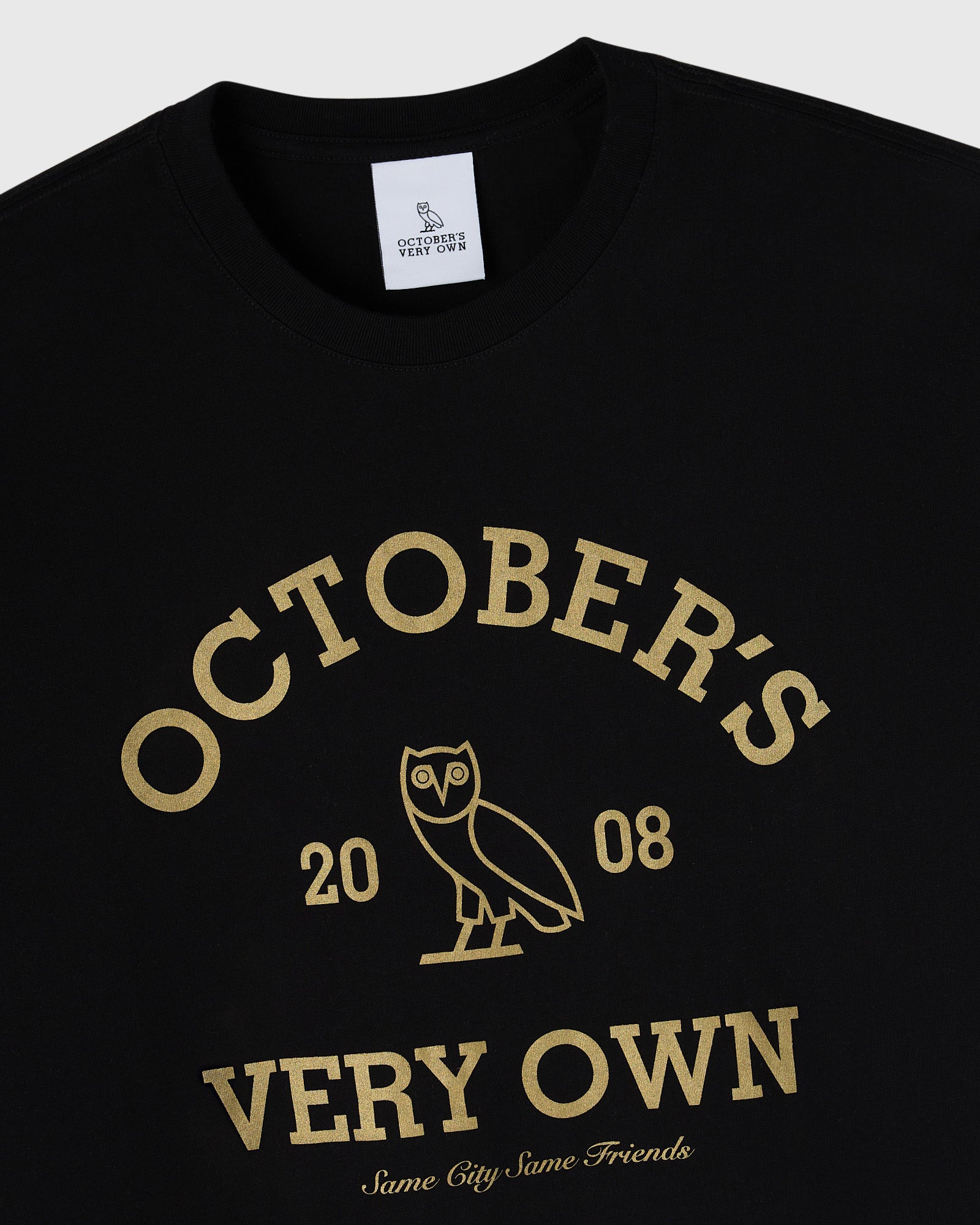 Black t-shirt with gold collegiate-style text reading "Octobers Very Own" and an owl graphic with "2008" underneath.