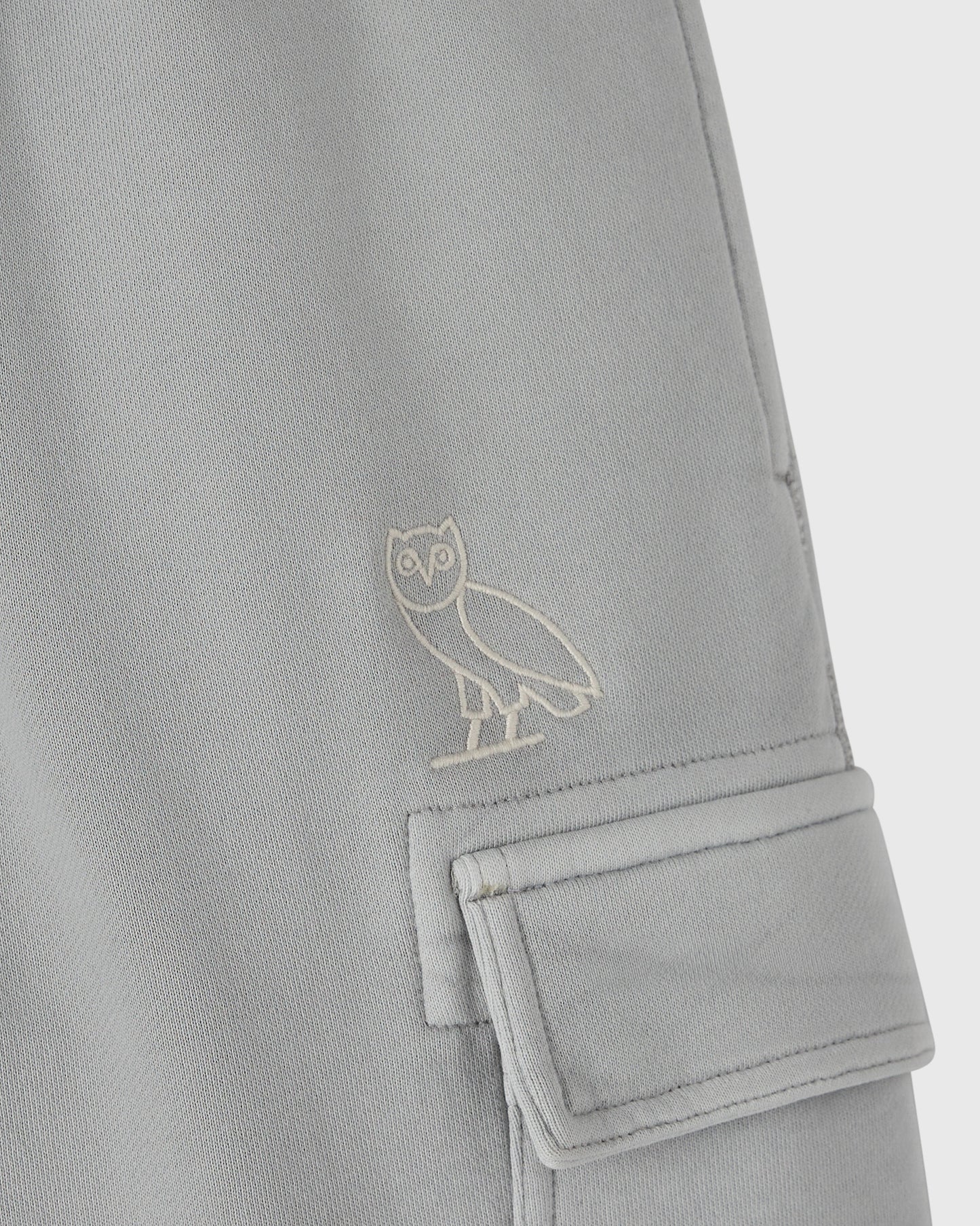 Gray sweatpant with embroidered owl logo and cargo pocket detail on the leg.