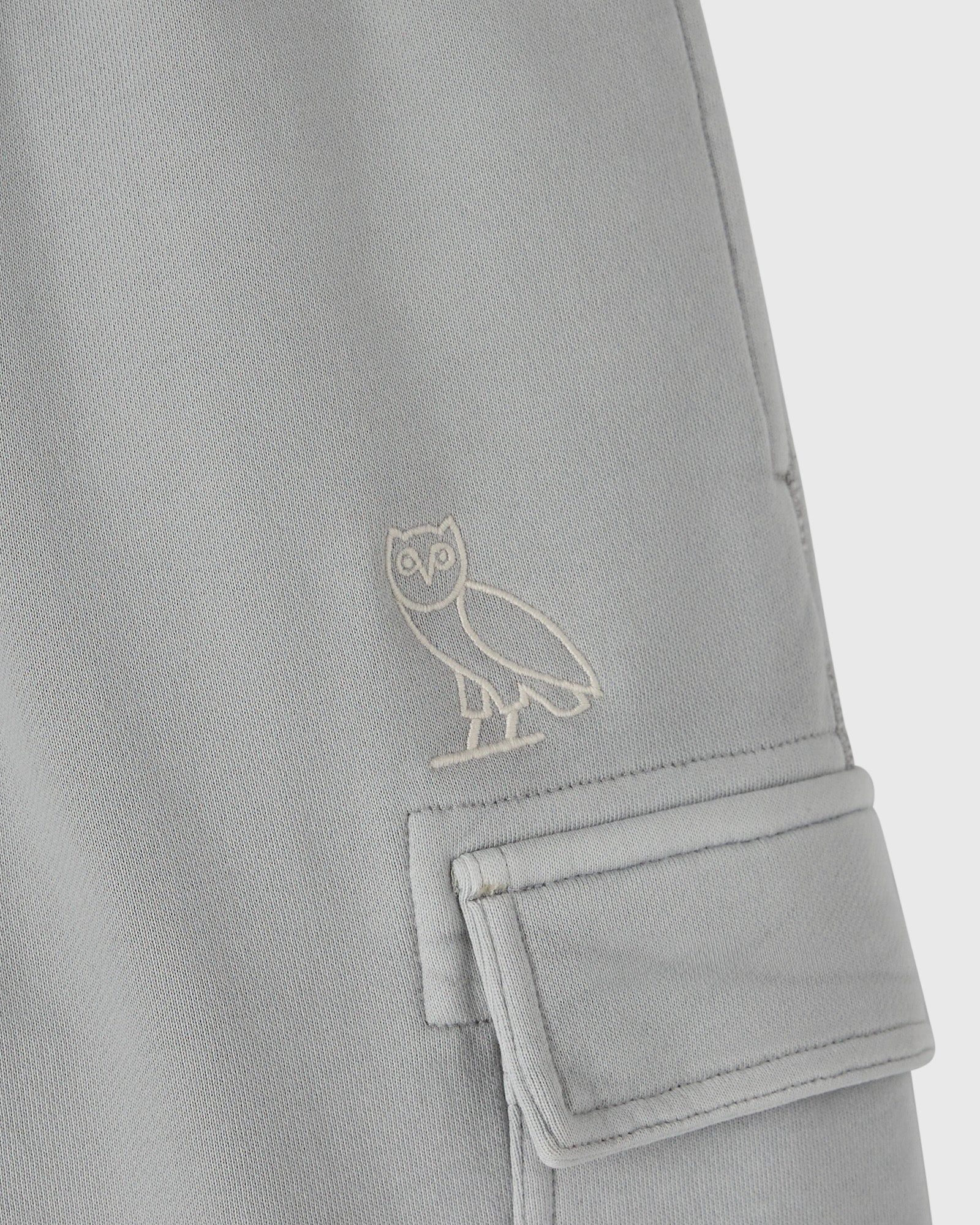 Gray sweatpant with embroidered owl logo and cargo pocket detail on the leg.