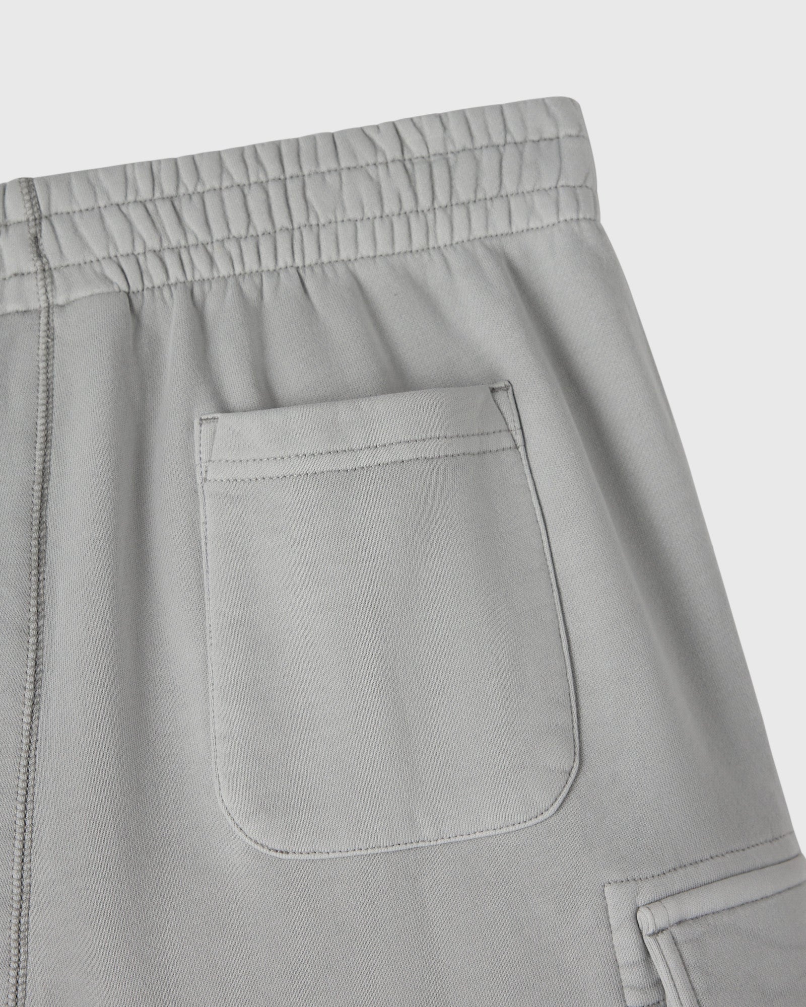 Gray sweatpant with elasticated waistband and cargo pocket detail on thigh.