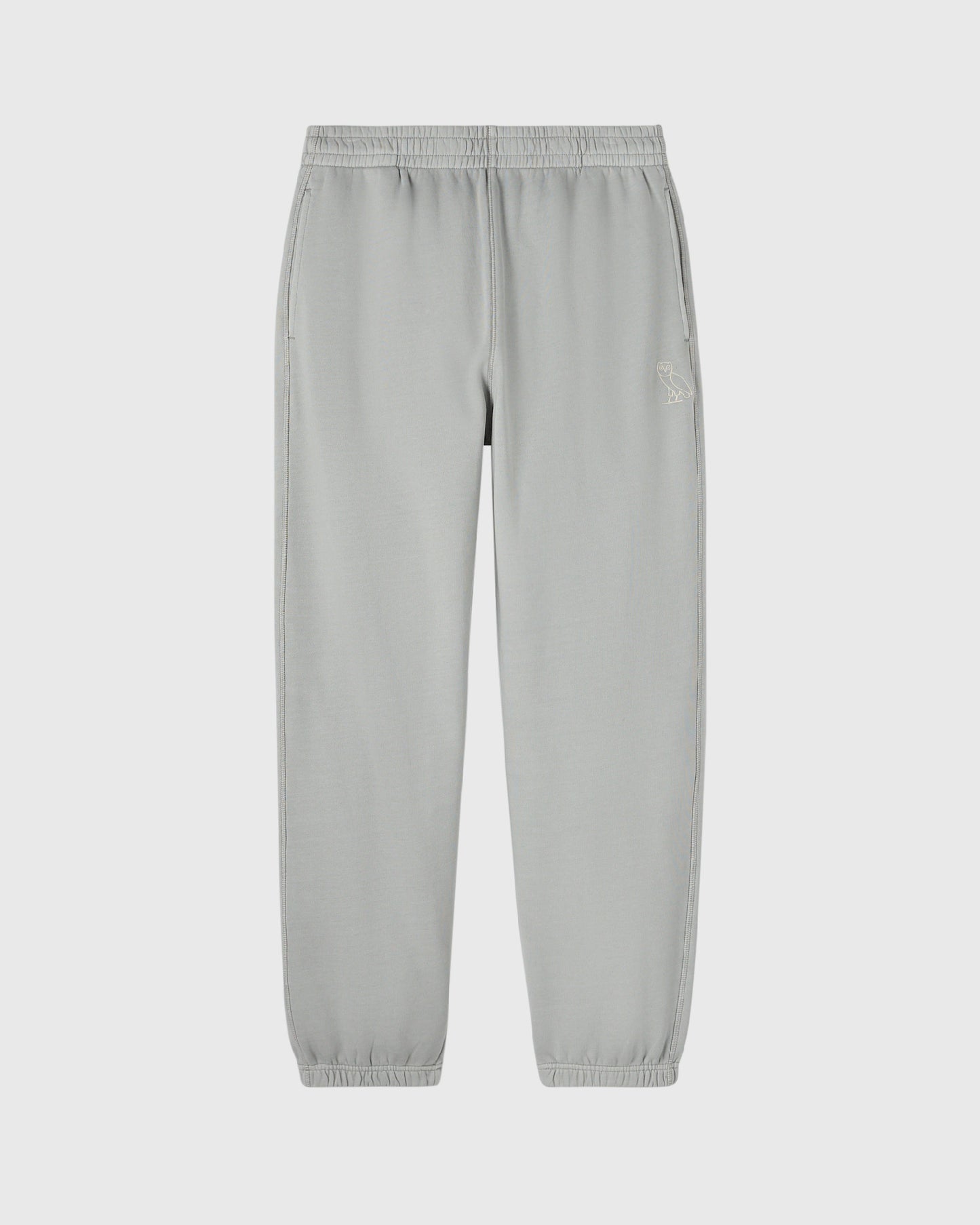 Gray sweatpants with elasticated waistband and cuffs, featuring a small embroidered logo on the thigh.