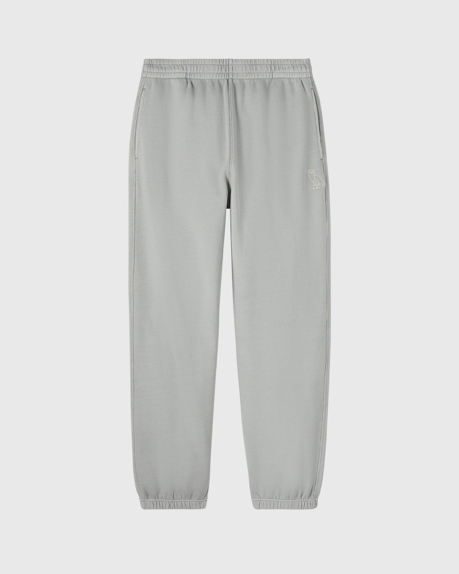 Gray sweatpants with elasticated waistband and cuffs, featuring a small embroidered logo on the thigh.