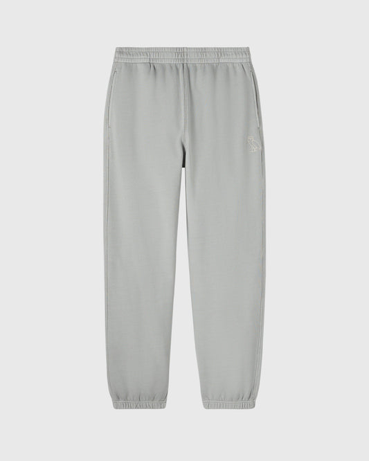 Gray sweatpants with elasticated waistband and cuffs, featuring a small embroidered logo on the thigh.