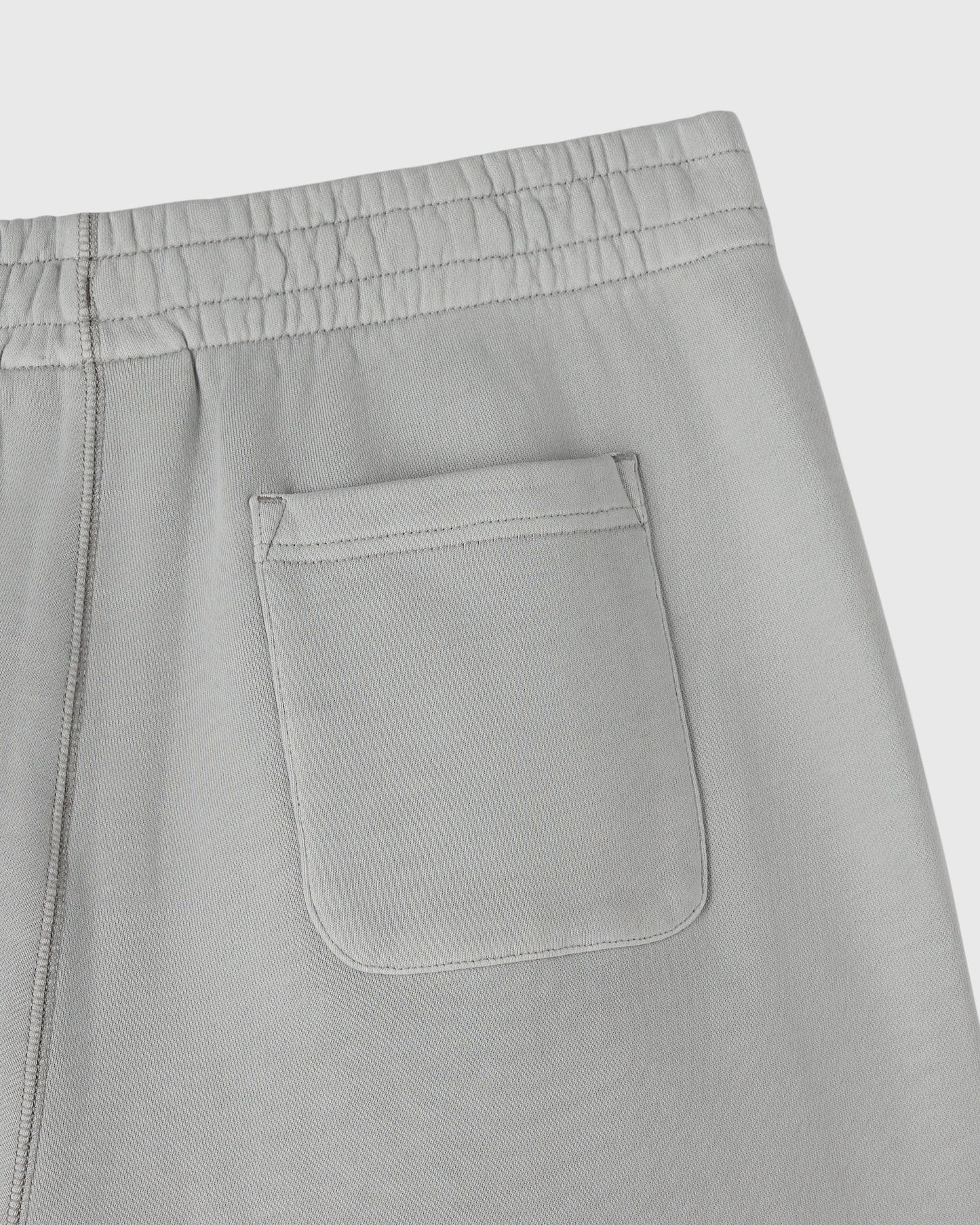 Gray sweatpants with elasticized waistband, side seam, and front patch pocket detail.