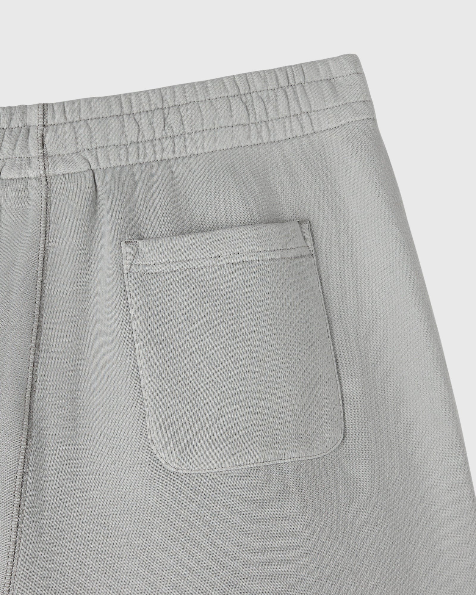 Gray sweatpants with elasticized waistband, side seam, and front patch pocket detail.