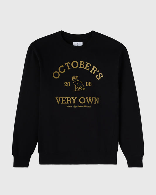 Black crewneck sweatshirt with gold text reading "October's Very Own" and an owl graphic.