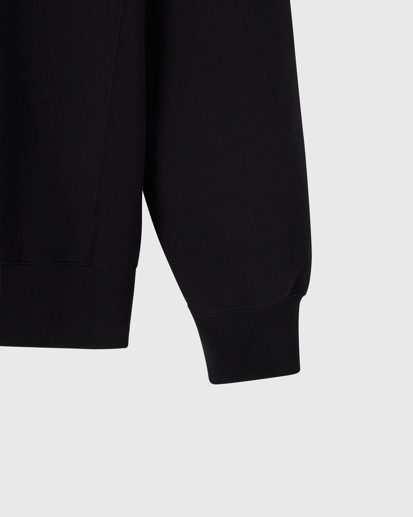 Black crewneck sweatshirt with ribbed cuffs and hem detail.