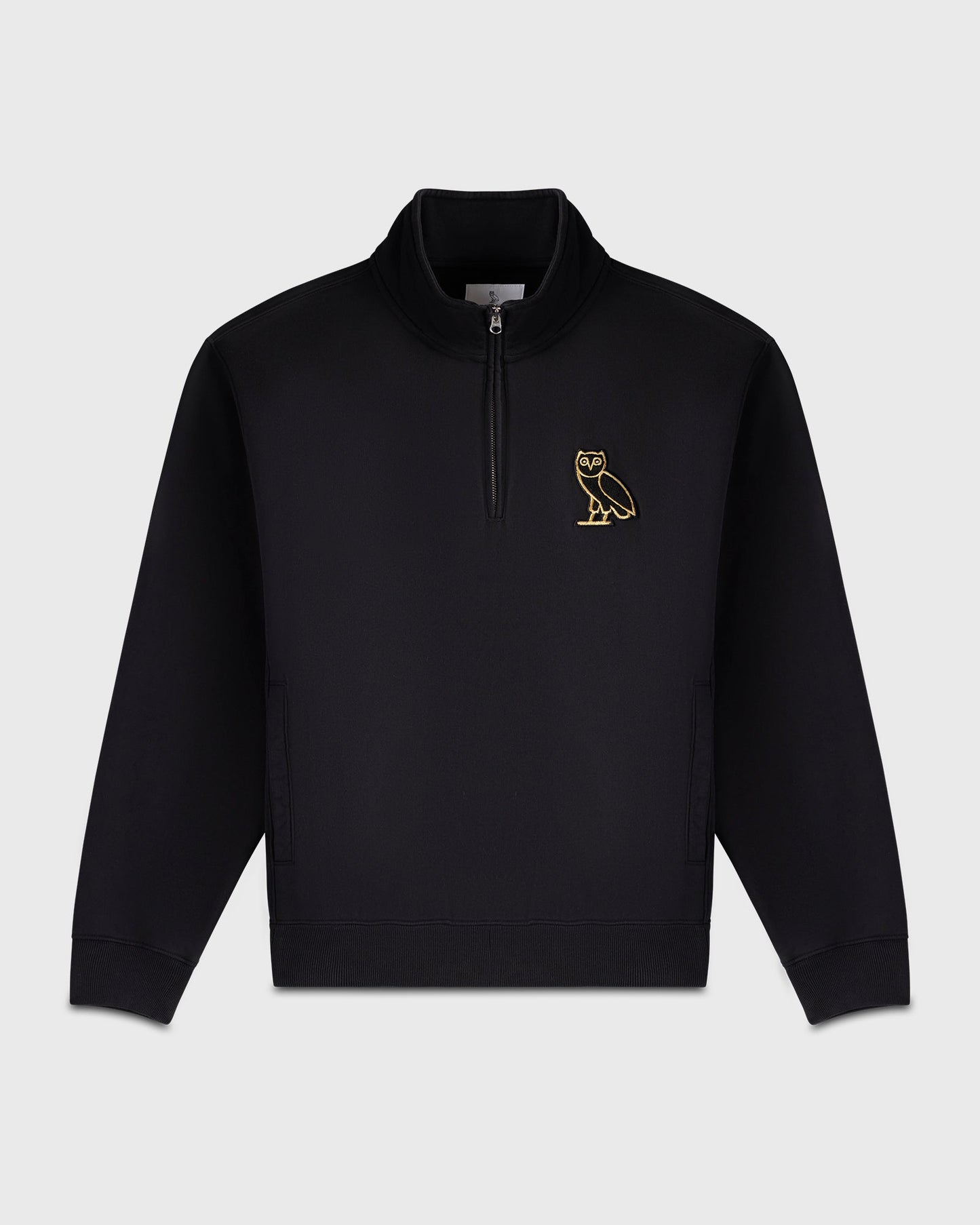 Black quarter-zip mockneck sweatshirt with gold owl embroidery on chest.