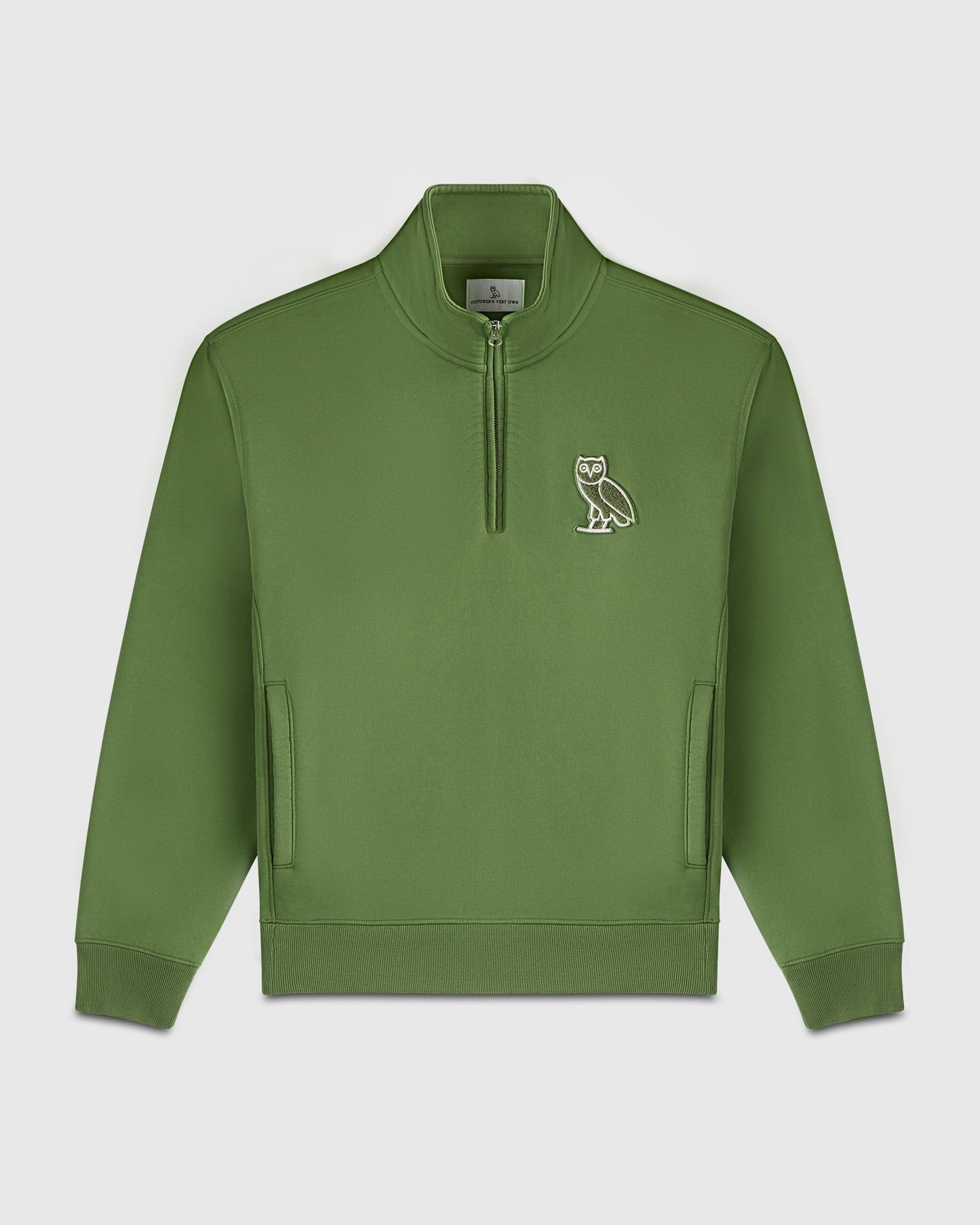 Green quarter-zip mockneck sweatshirt with owl embroidery on chest and front hand pockets.