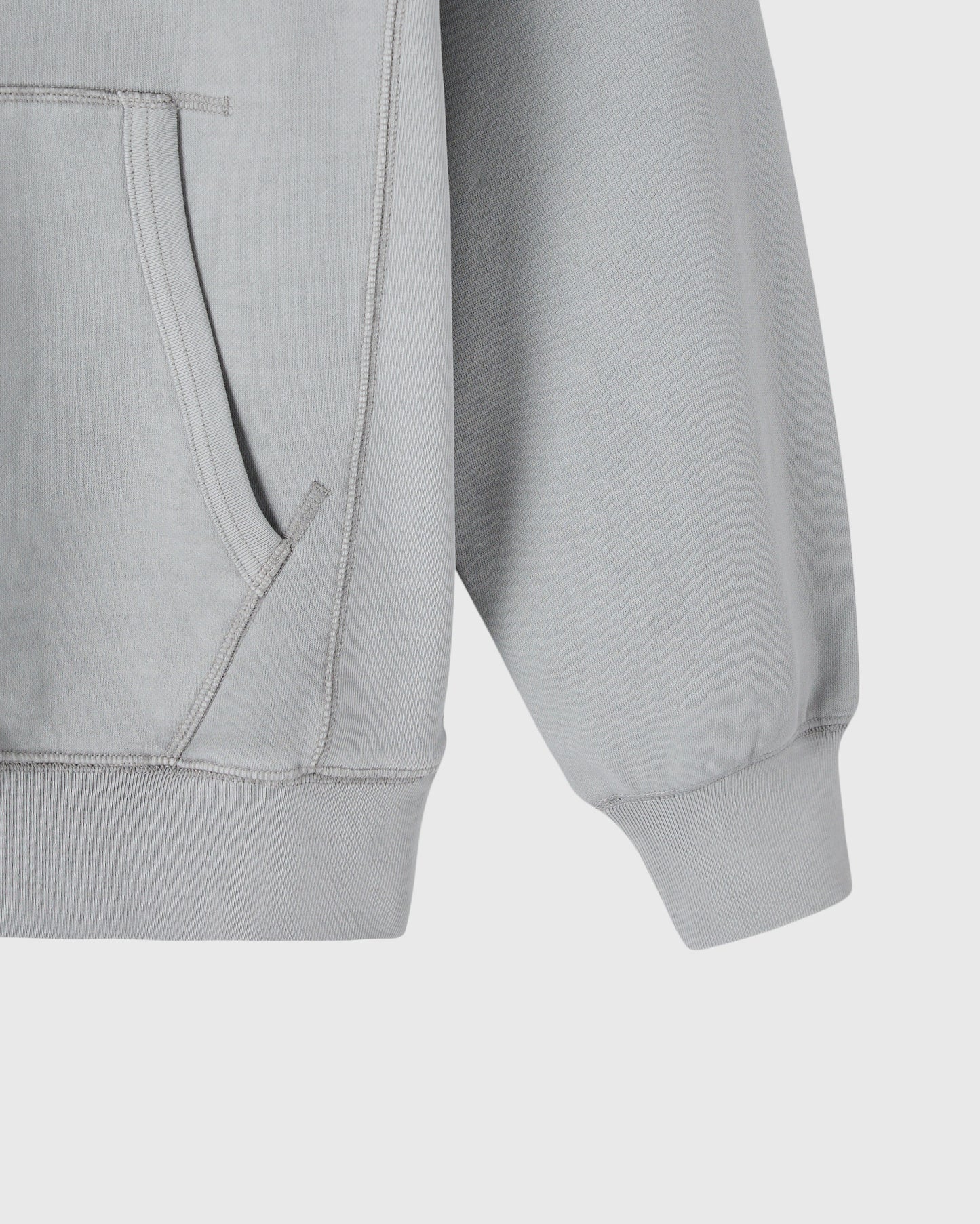Gray raglan hoodie with ribbed cuffs and kangaroo pocket, front detail view.