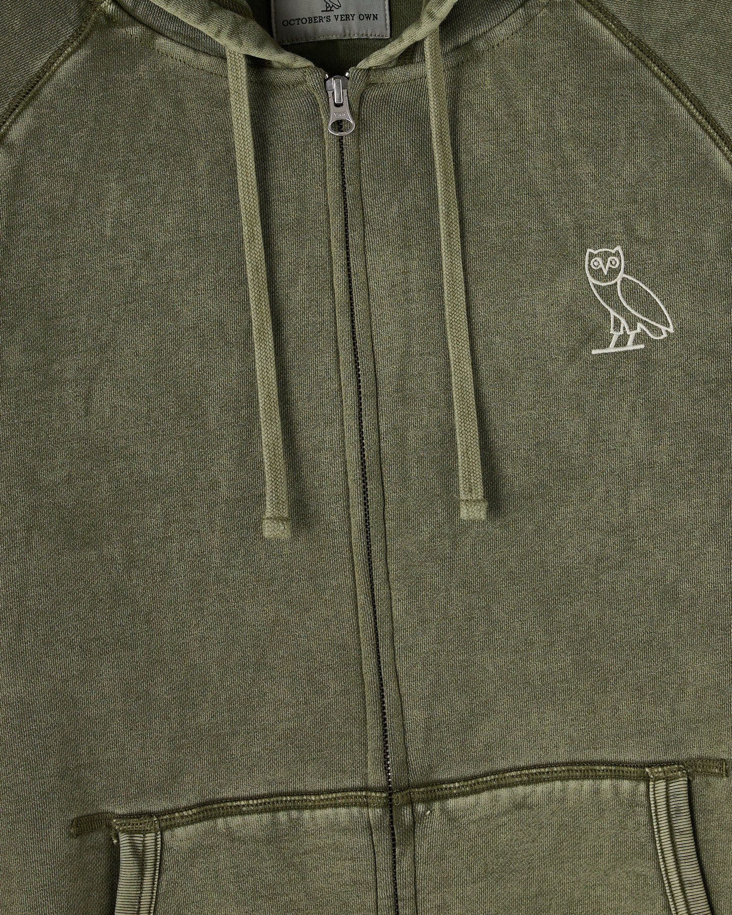Cypress green full-zip hoodie with raglan sleeves, drawstring hood, and small owl logo on chest.