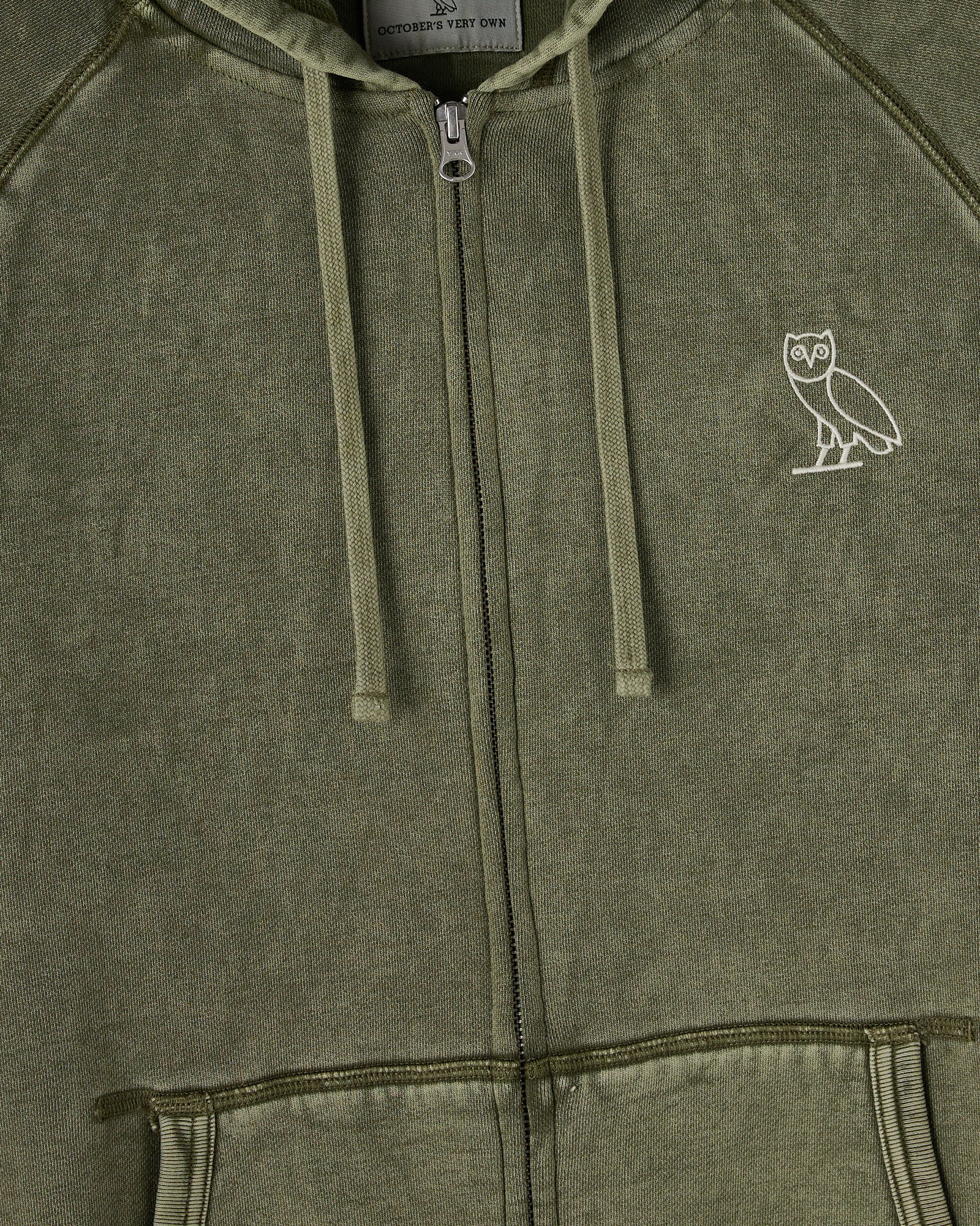Cypress green full-zip hoodie with raglan sleeves, drawstring hood, and small owl logo on chest.