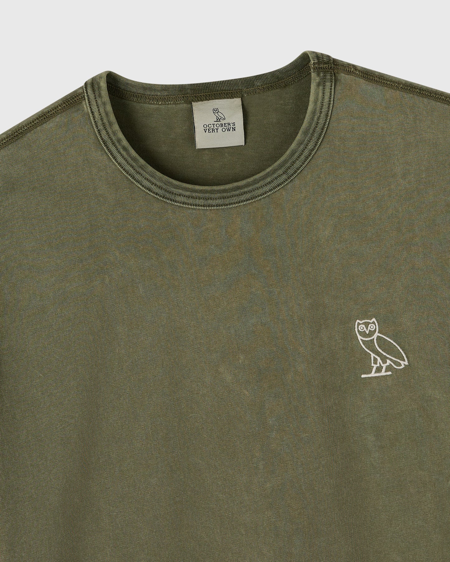 Cypress green long-sleeve tee with crew neckline and small owl emblem on chest.