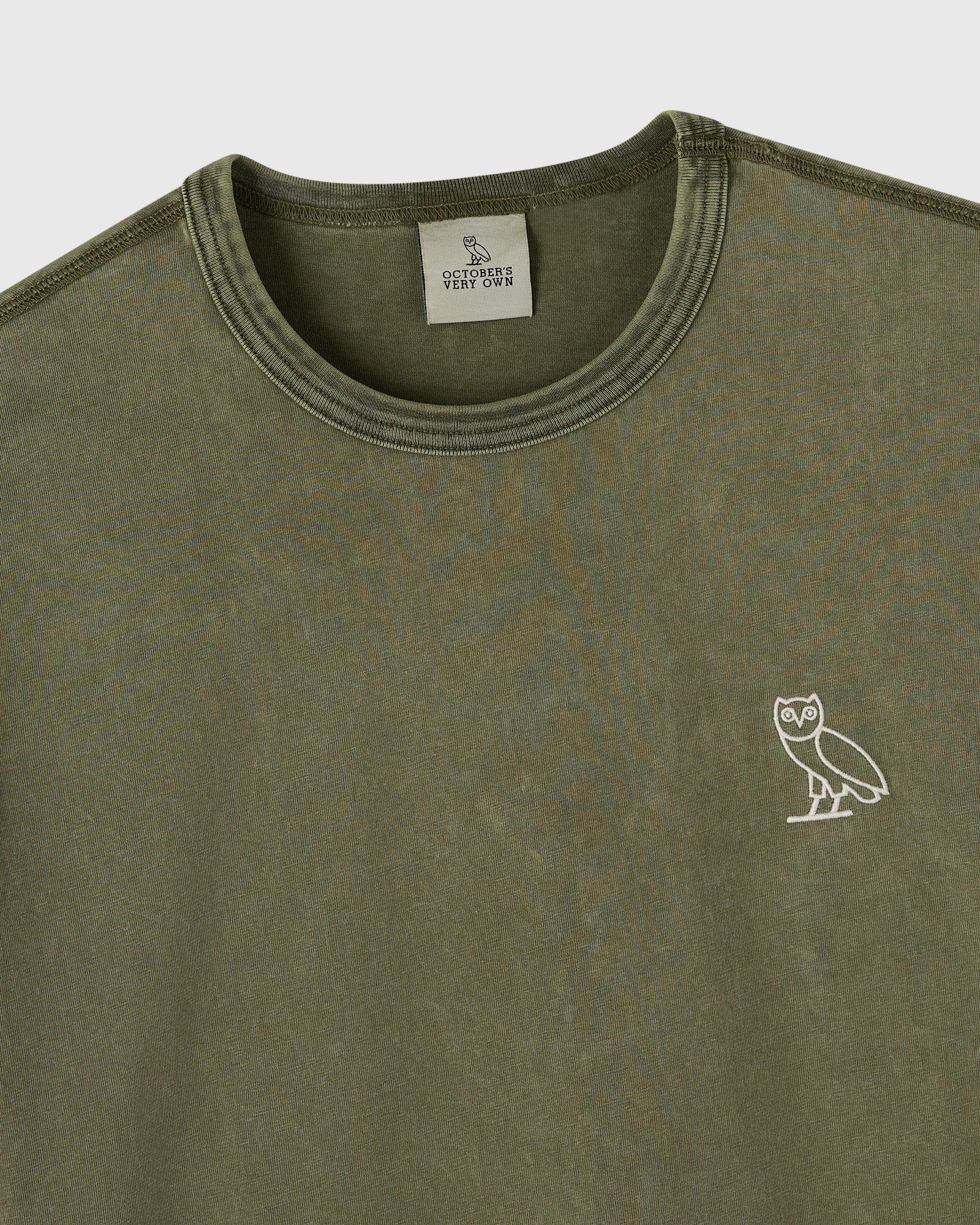 Cypress green long-sleeve tee with crew neckline and small owl emblem on chest.