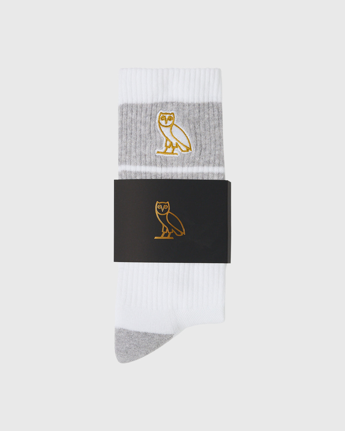 White crew socks with gray heel and toe, featuring gold owl emblem on gray stripe band.