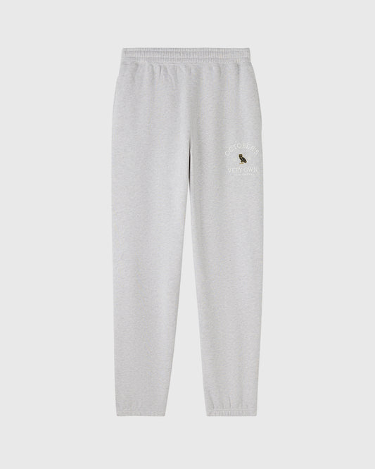 Ash heather grey sweatpants with ribbed waistband and cuffs, featuring embroidered text and logo on thigh.