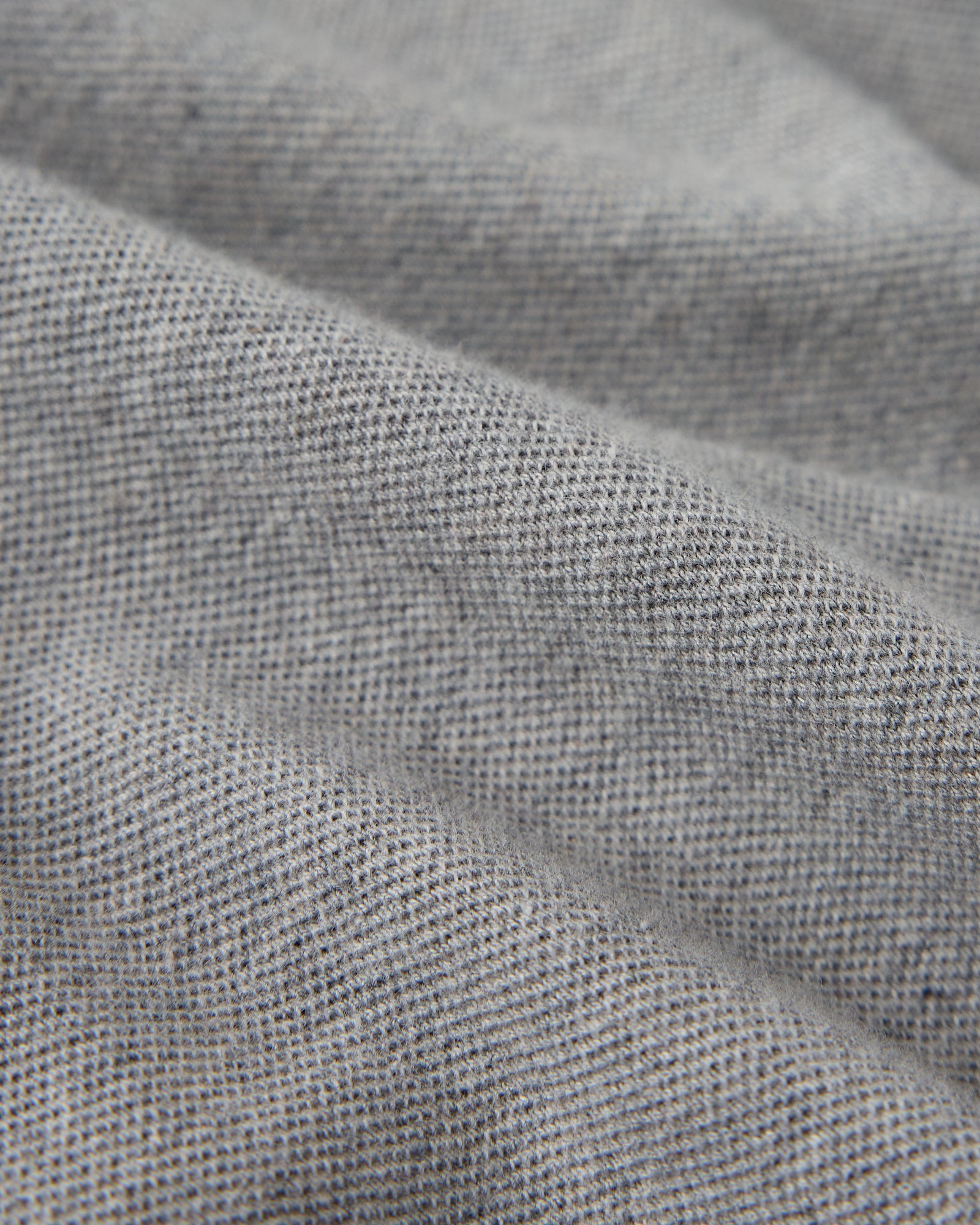 Heather grey polo shirt with textured cotton piqué weave fabric and collar detail.