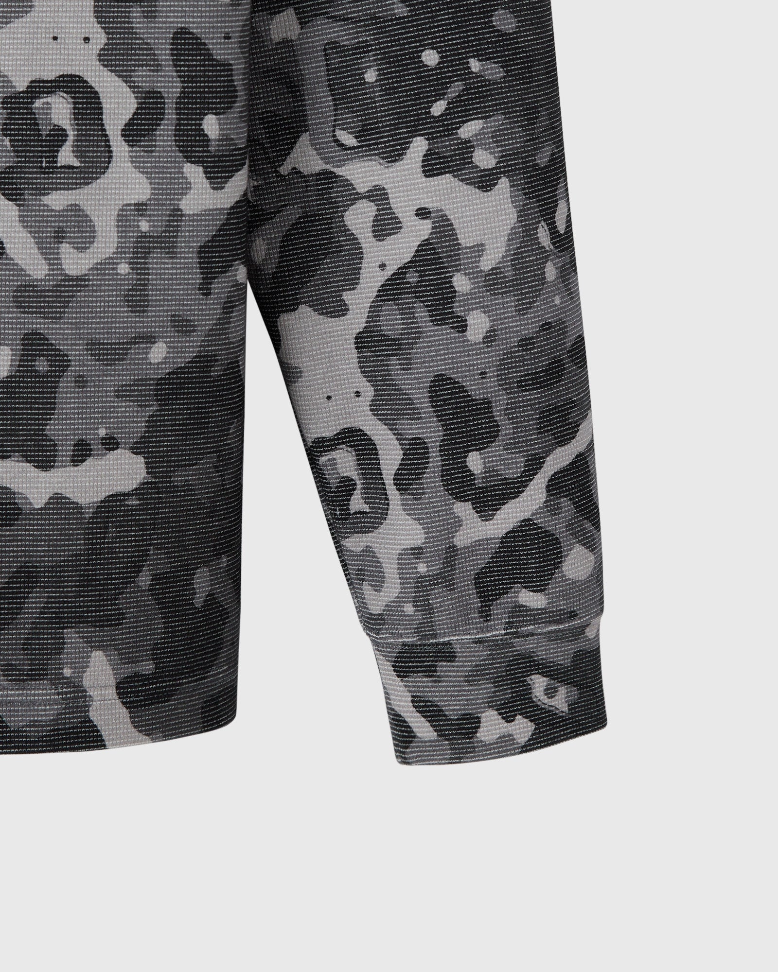 Grey and black camouflage long-sleeve tee with textured fabric and fitted sleeves.