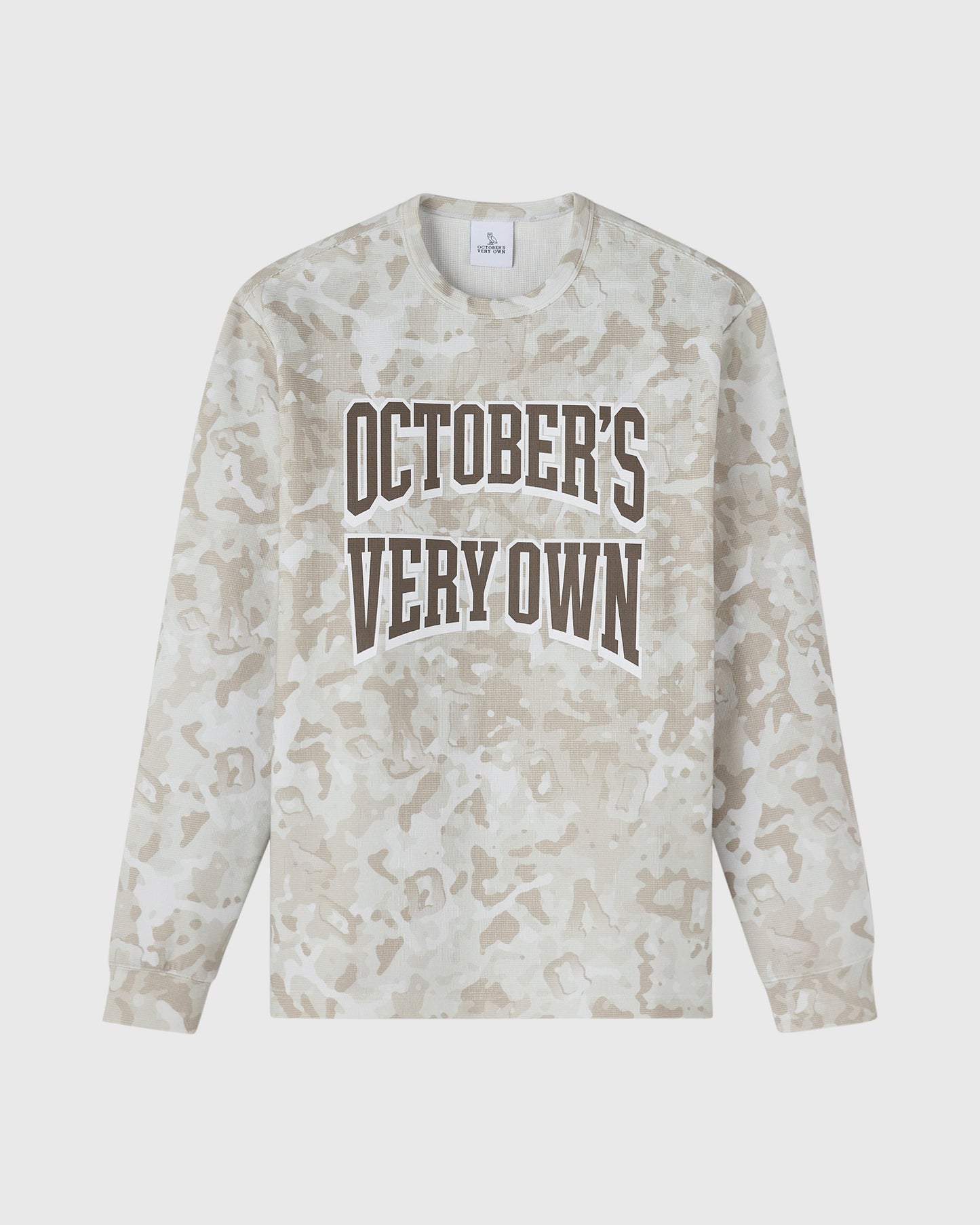 Long-sleeve tee in tan desert camouflage print with "October's Very Own" text graphic on chest.