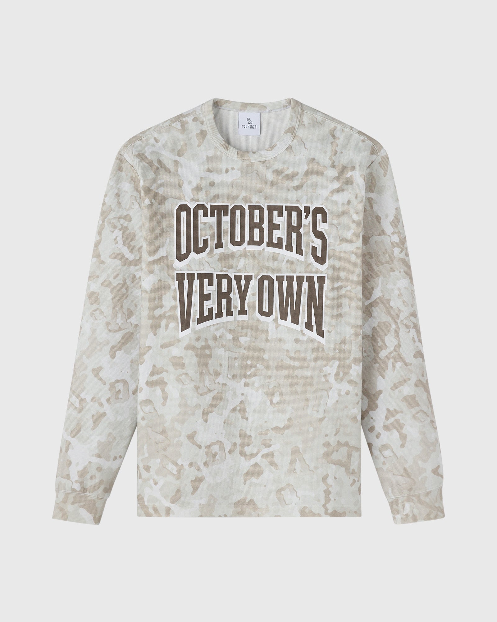 Long-sleeve tee in tan desert camouflage print with "October's Very Own" text graphic on chest.