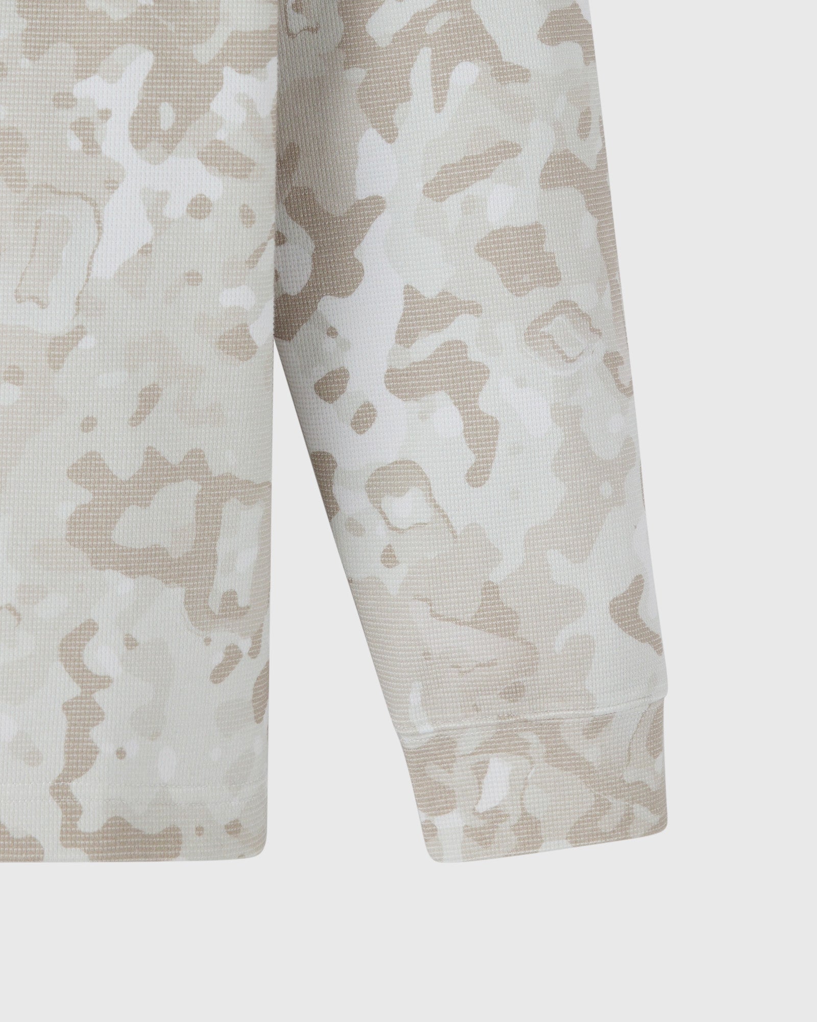 Long-sleeve tee with beige and white desert camouflage pattern and textured waffle knit fabric.