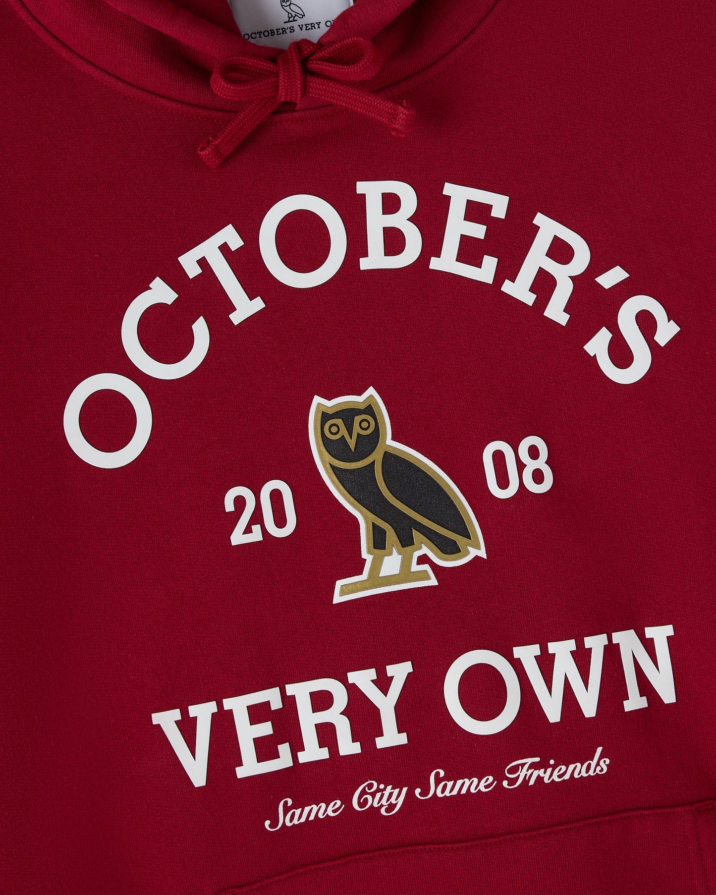 Deep red hoodie with white "October's Very Own" text, owl graphic, and "Same City Same Friends" slogan.