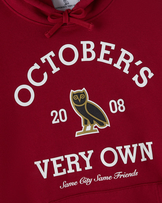 Deep red hoodie with white "October's Very Own" text, owl graphic, and "Same City Same Friends" slogan.