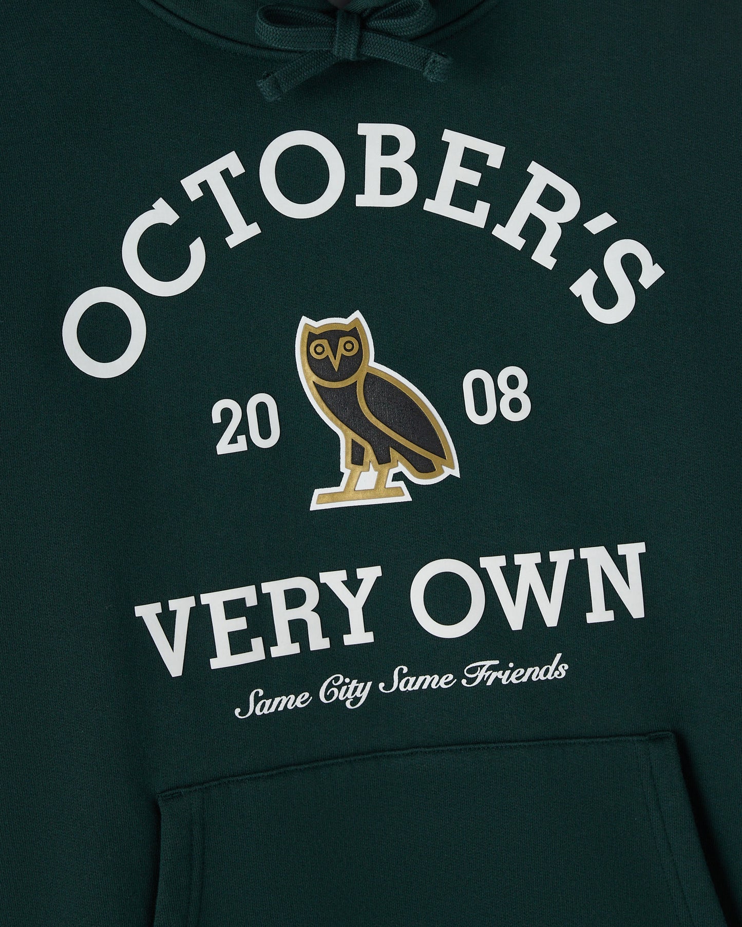 Midnight green hoodie with white "Octobers" text, owl graphic, "2008" numbers, and cursive script below on chest.