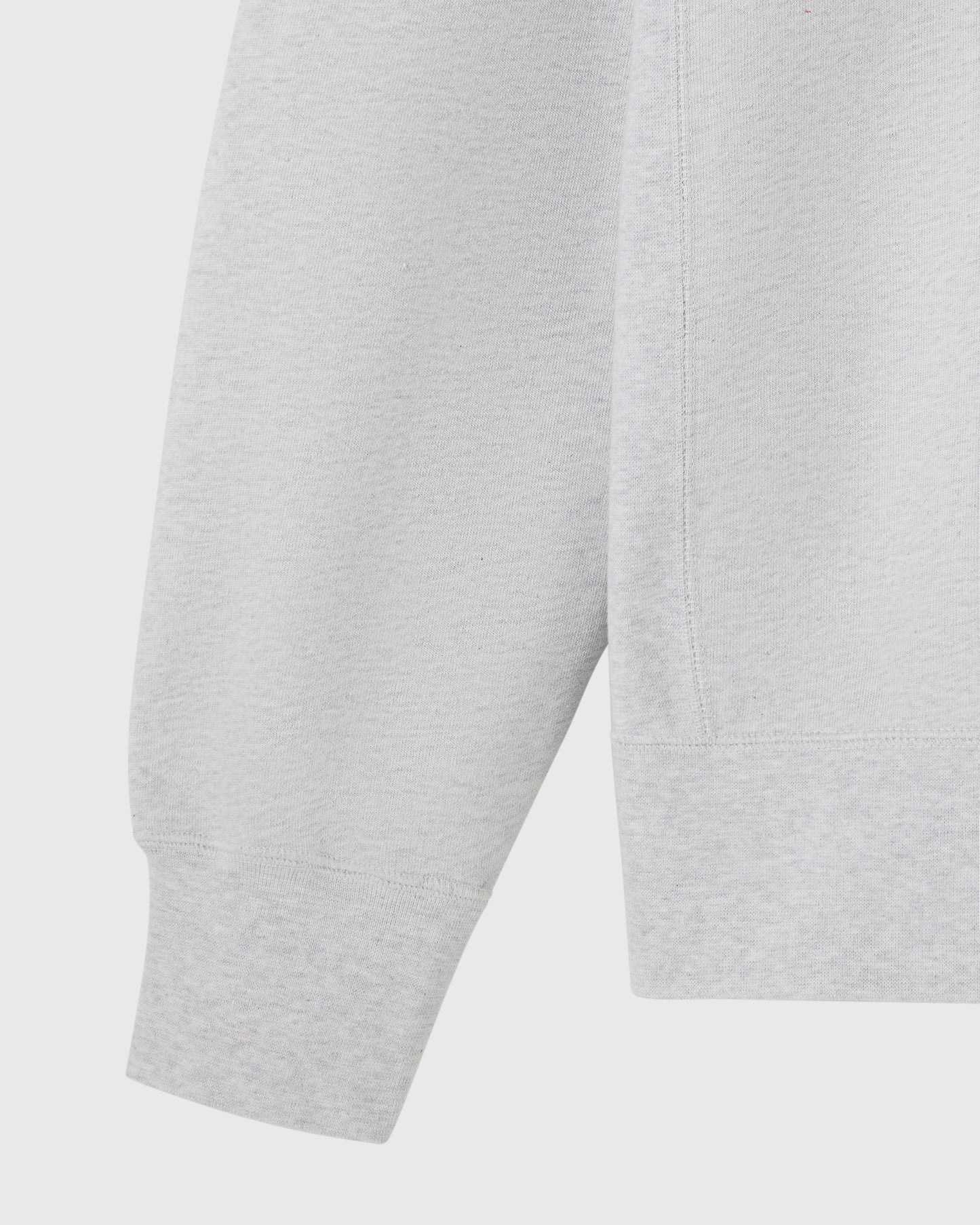 Ash heather grey crewneck sweatshirt showing sleeve and torso detail.