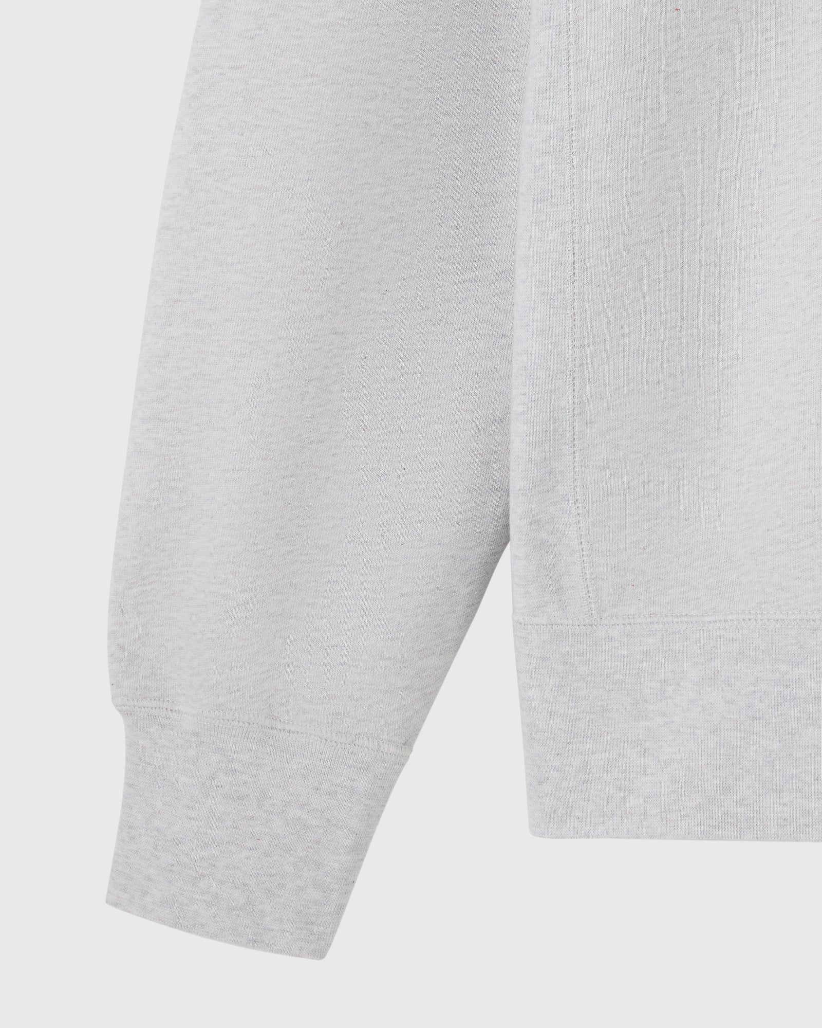 Ash heather grey crewneck sweatshirt showing sleeve and torso detail.