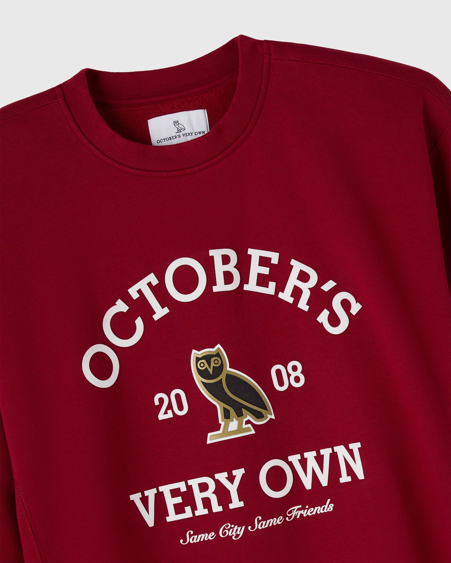Deep red crewneck sweatshirt with "October's Very Own" text, owl graphic, and "20 08" printed on chest.