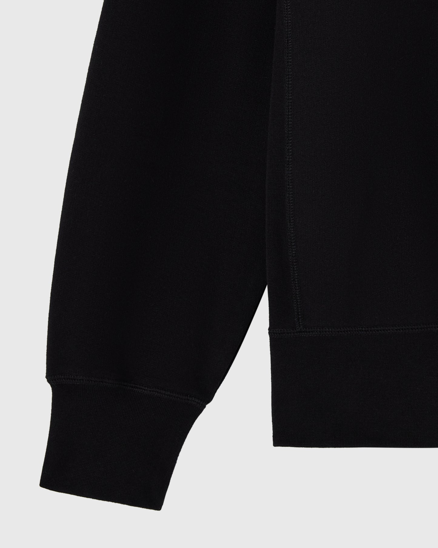 Black crewneck sweatshirt with ribbed cuffs and hem detail.