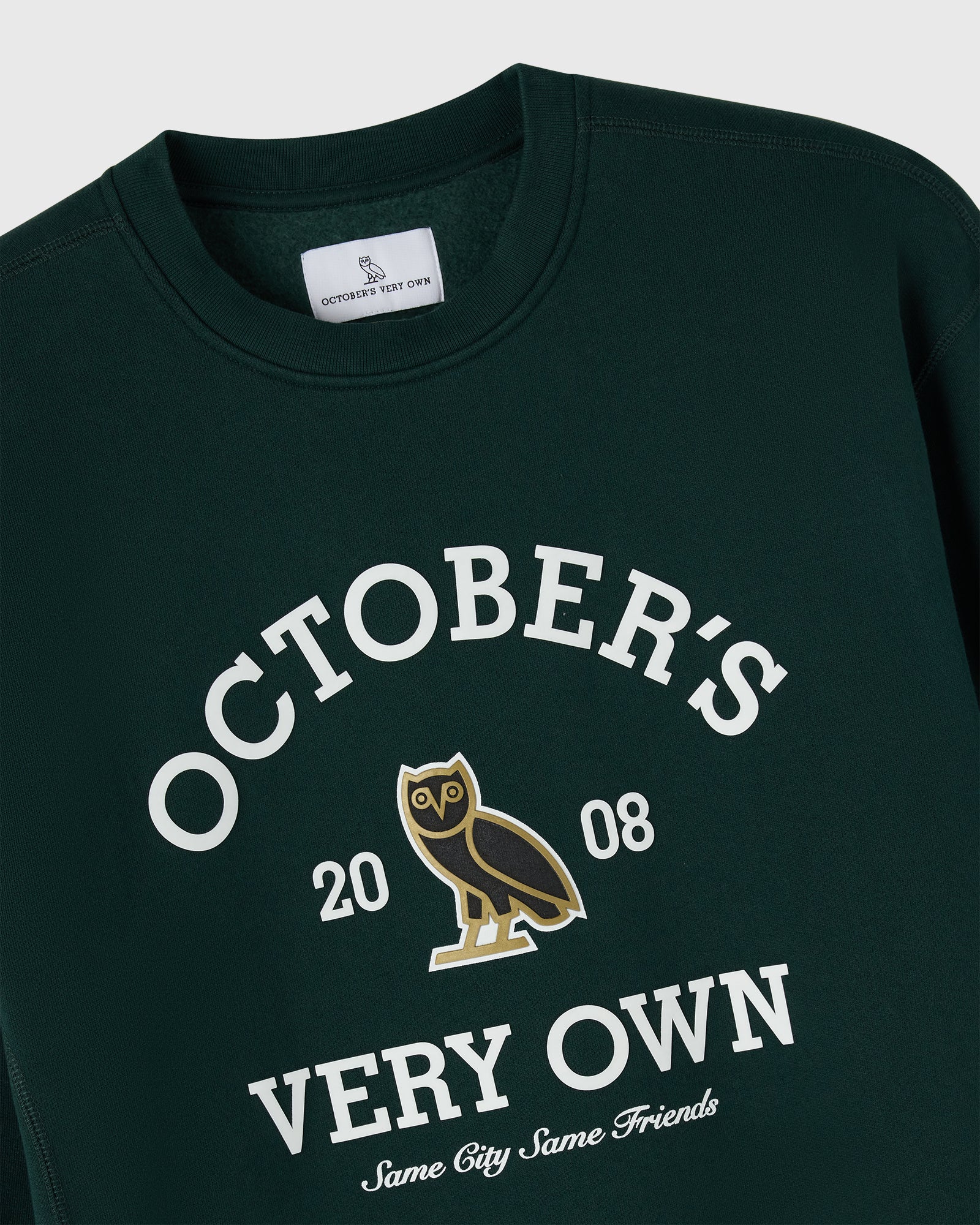 Midnight green crewneck sweatshirt with white "October's Very Own" text, owl graphic, and "2008" print.