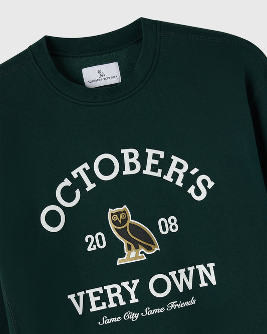 Midnight green crewneck sweatshirt with white "October's Very Own" text, owl graphic, and "2008" print.