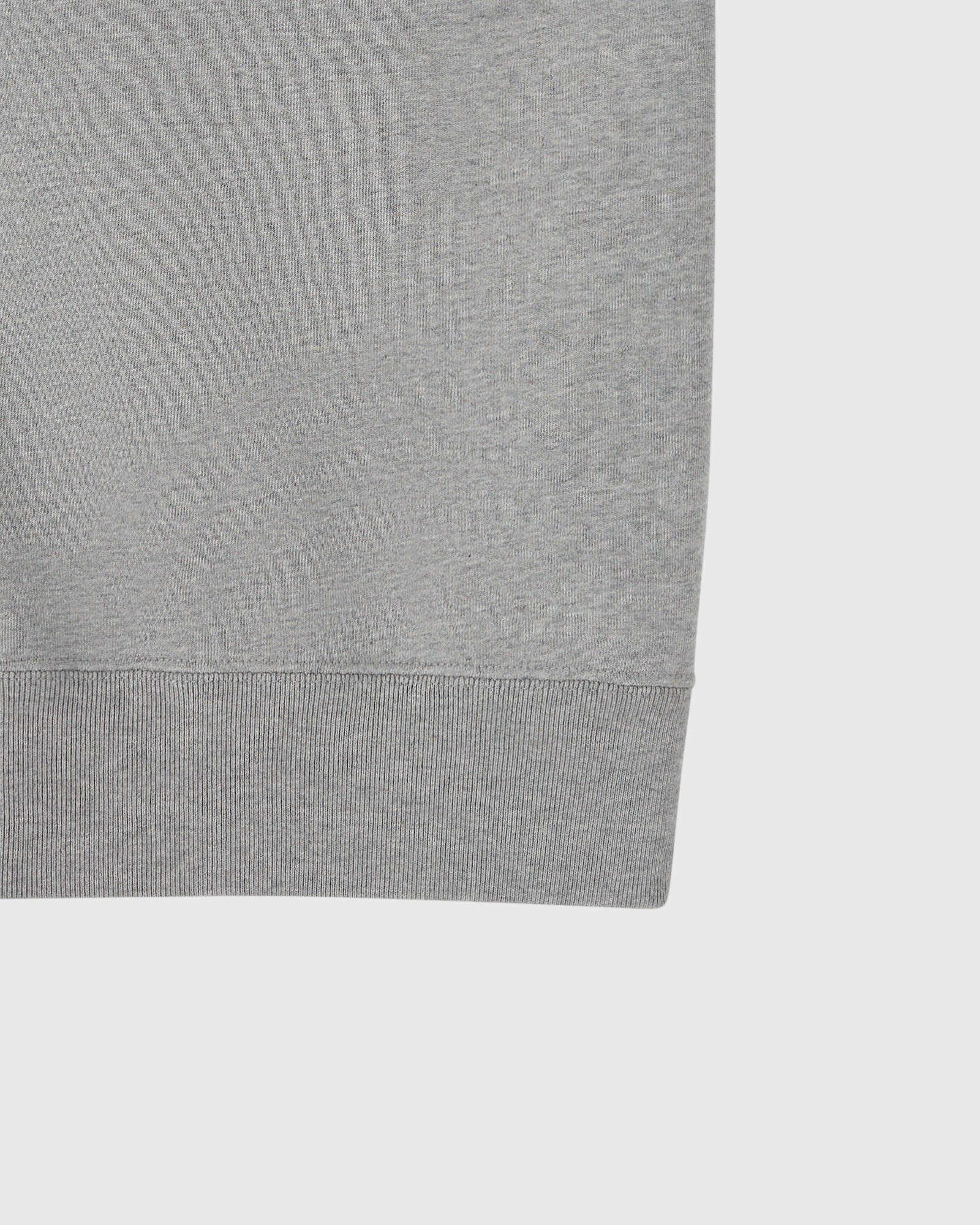 Heather grey sleeveless vest with ribbed trim at bottom hem.