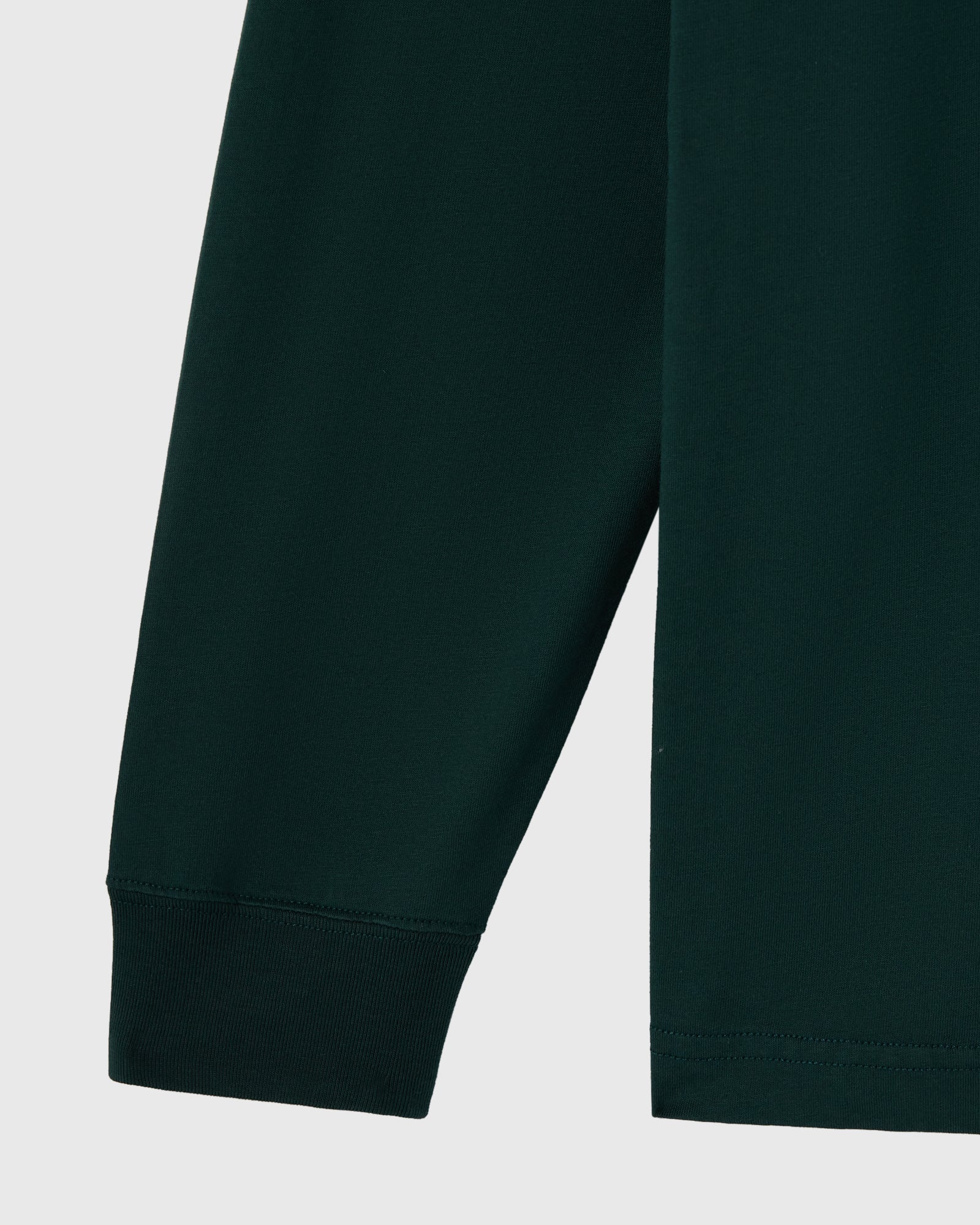 Midnight green long-sleeve tee with ribbed cuffs and hem detail.