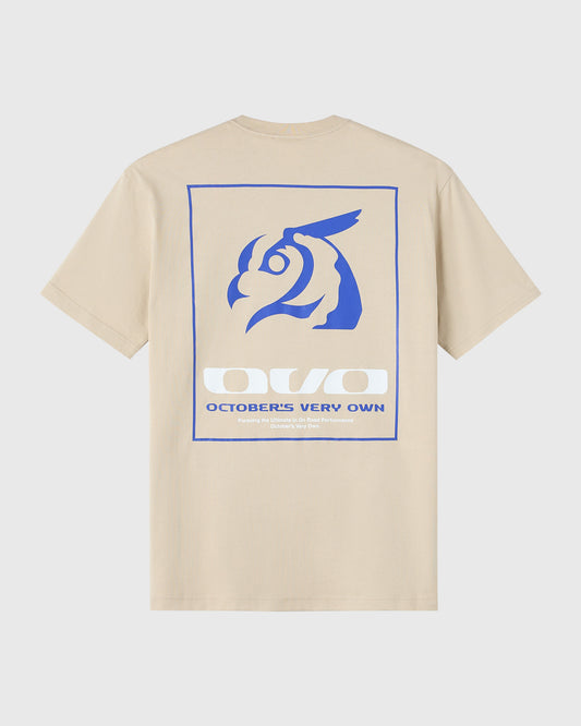 Sandstone t-shirt with blue graphic featuring stylized horned animal head and "October's Very Own" text on back.