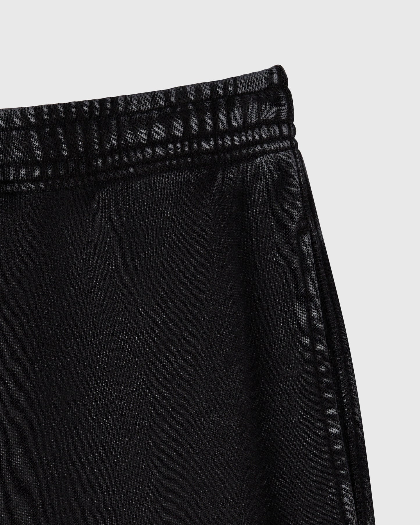 Black cargo sweatpant with drawstring waistband and textured knit fabric.