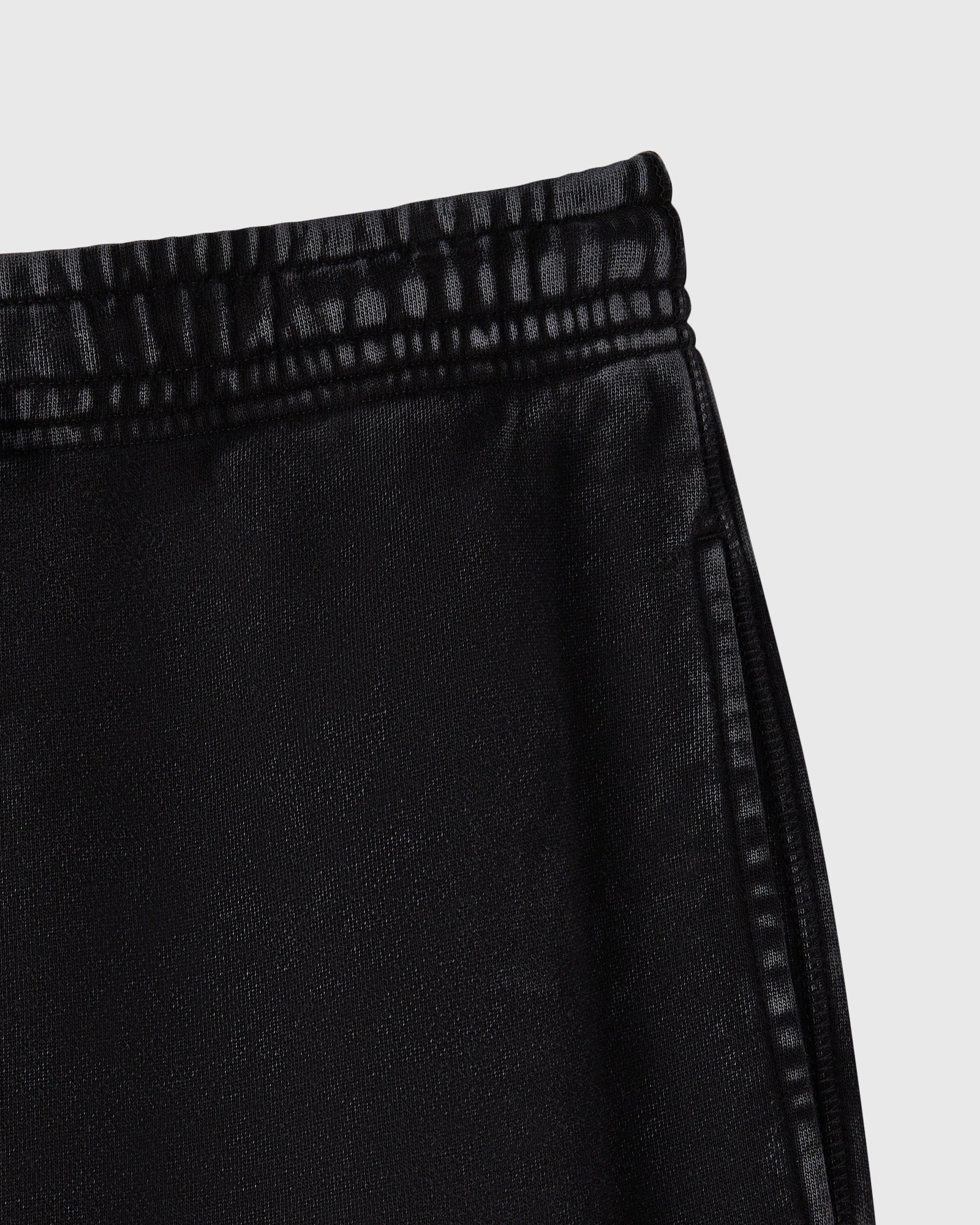 Black cargo sweatpant with drawstring waistband and textured knit fabric.