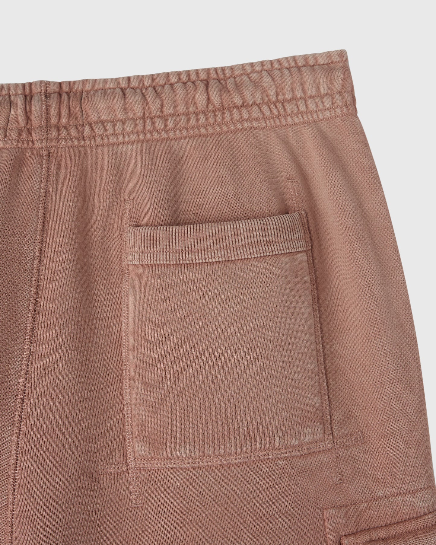 Clay pink cargo sweatpant with elastic waistband and patch pocket detail on thigh.