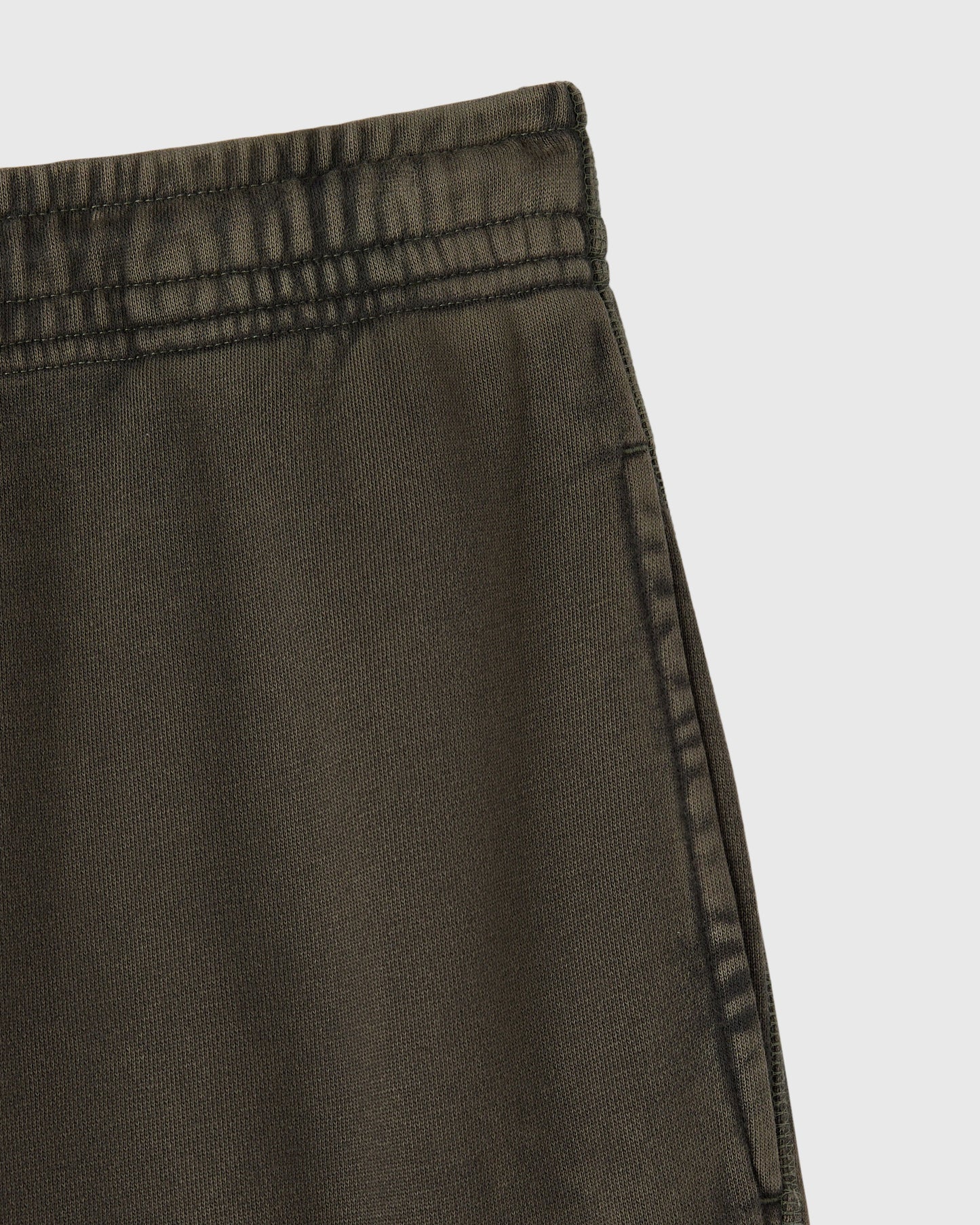 Deep olive cargo sweatpant with ribbed waistband and side seam detail.