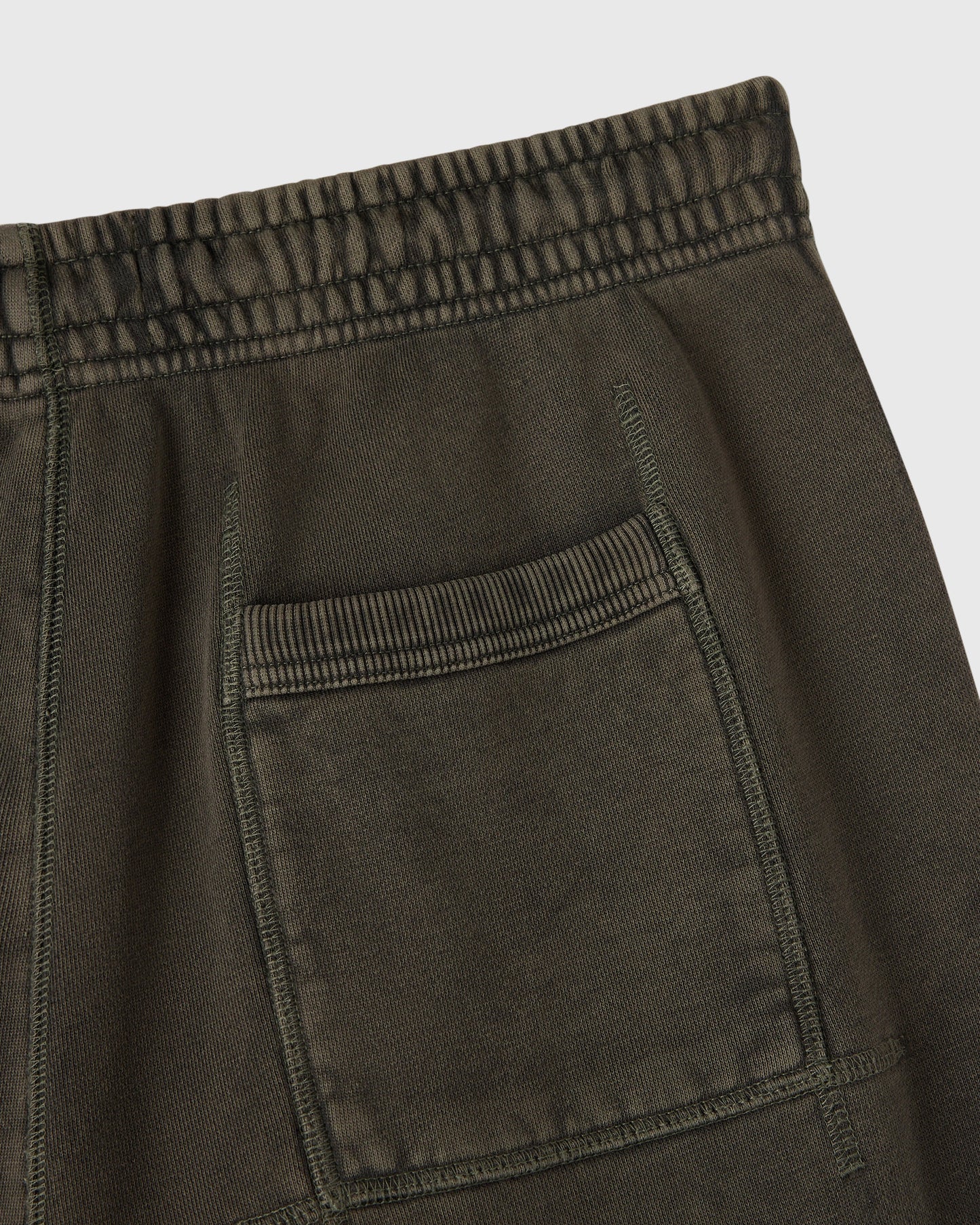 Deep olive sweatpants with elasticated waistband, drawstring, and front pocket detail.