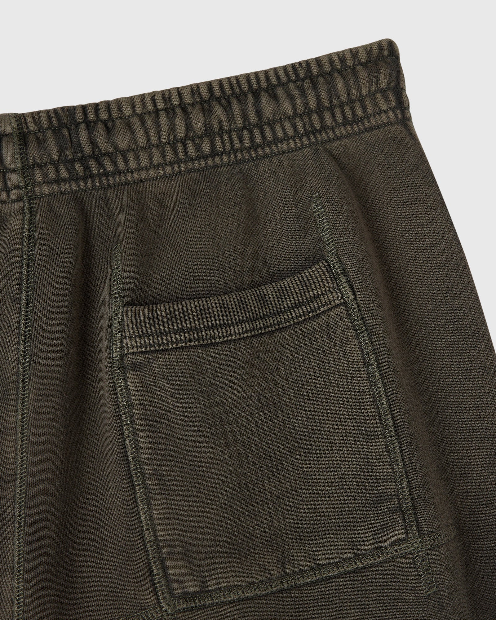 Deep olive sweatpants with elasticated waistband, drawstring, and front pocket detail.
