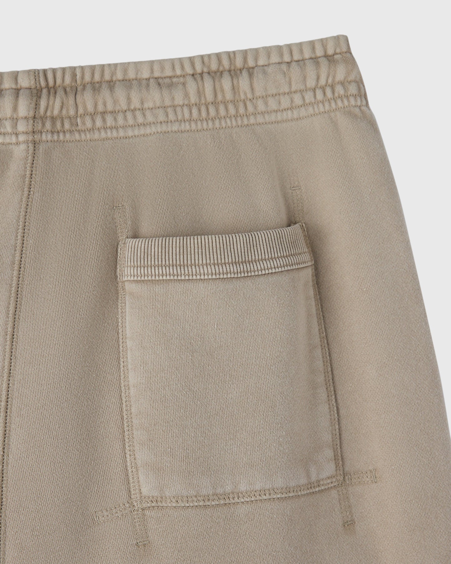 Sandstone cargo sweatpant with elasticated waistband and front patch pocket detail.