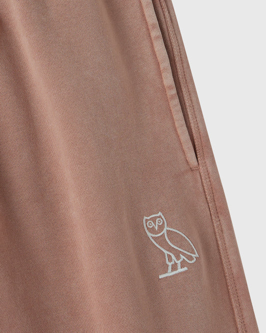 Clay pink sweatpant with white owl embroidery on leg and side seam detail.