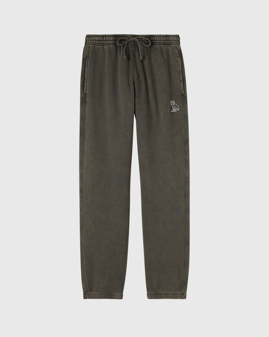 Deep olive sweatpants with drawstring waist and small owl logo on thigh.