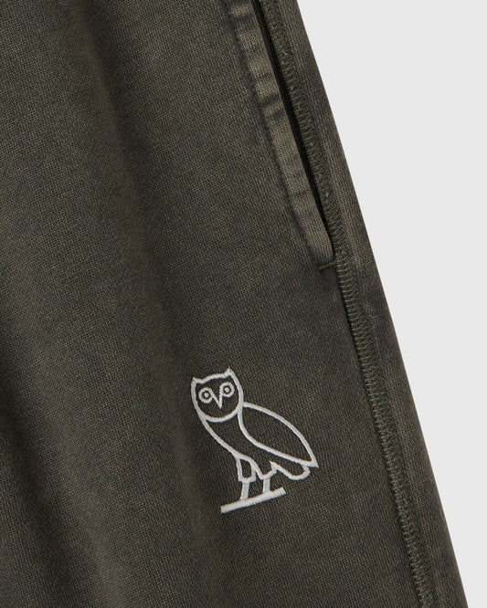 Deep olive sweatpant with white owl embroidery on thigh and side seam detail.