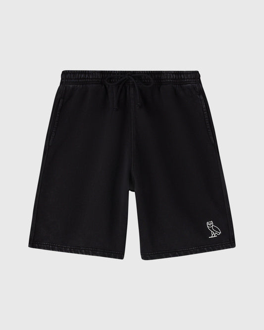 Black sweatshorts with drawstring waist, side pockets, and small owl emblem on right leg.