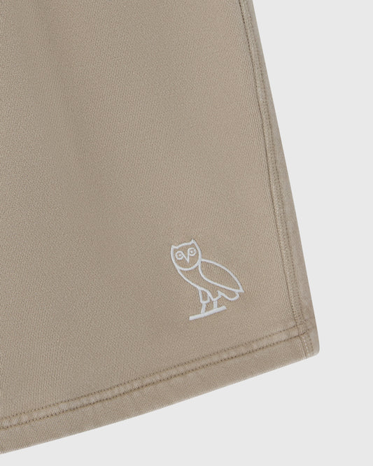 Sandstone sweatshorts with white embroidered owl logo on leg.