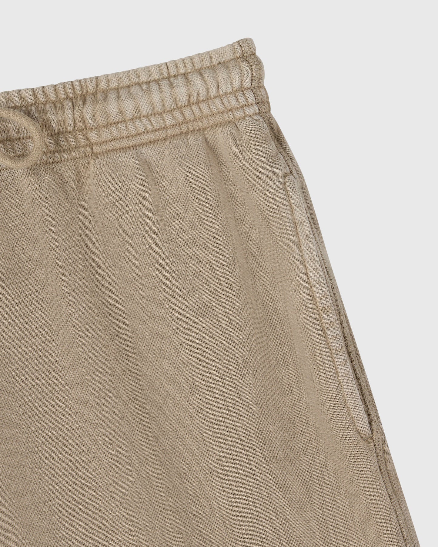 Sandstone sweatshorts with elastic waistband and side seam detail.